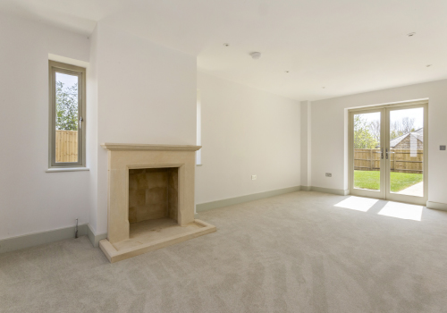 Spacious lounge with a working fireplace and views looking out over the garden.