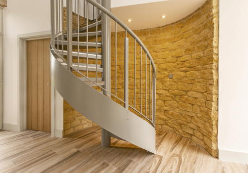 A beautiful spiral staircase which leads up to a space above the double garage which, with its en suite facilities, may be utilised as a home office or guest suite.